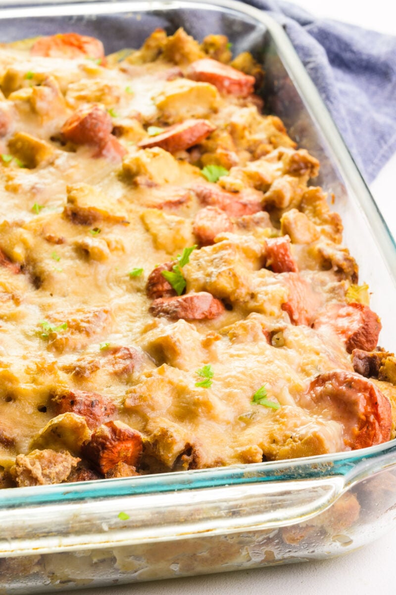 A casserole dish is full of vegetarian Thanksgiving casserole. There's a kitchen towel in the background.