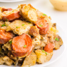 Vegan holiday casserole sits on a plate, showcasing carrots and tofu.