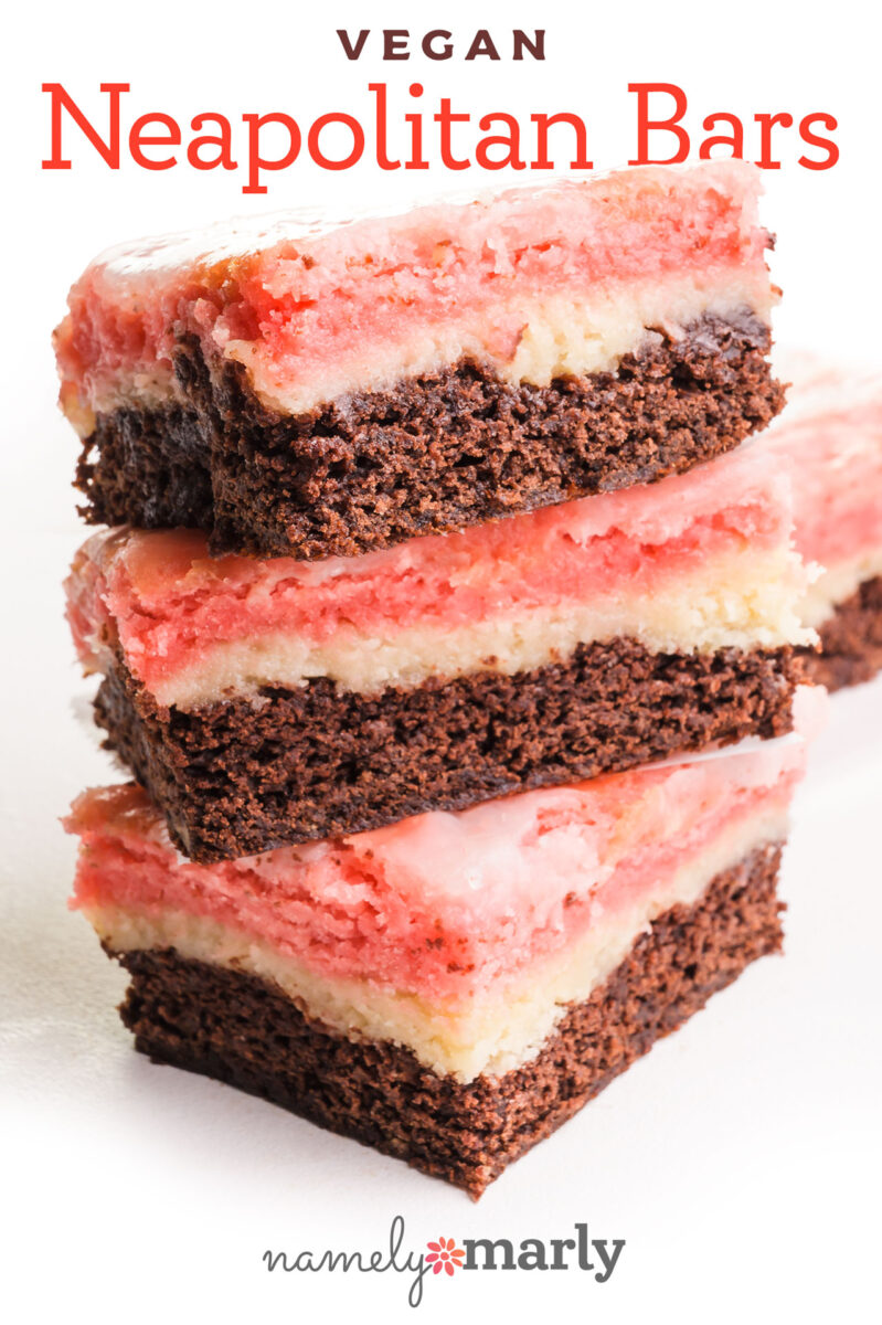 Stack of vegan Neapolitan bars with chocolate, vanilla, and strawberry layers against a white background.
