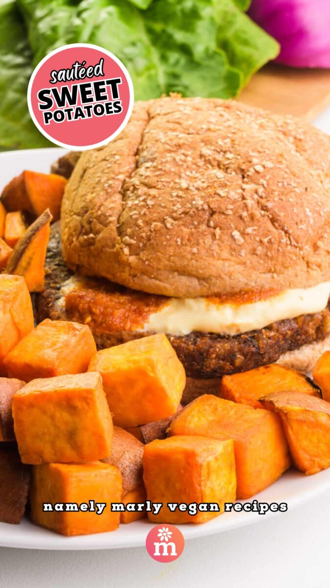 Sweet potato cubes are on a plate next to a veggie burger. Burger toppings are on a cutting board in the background. The text reads, Sautéed Sweet Potatoes: Namely Marly Vegan Recipes.