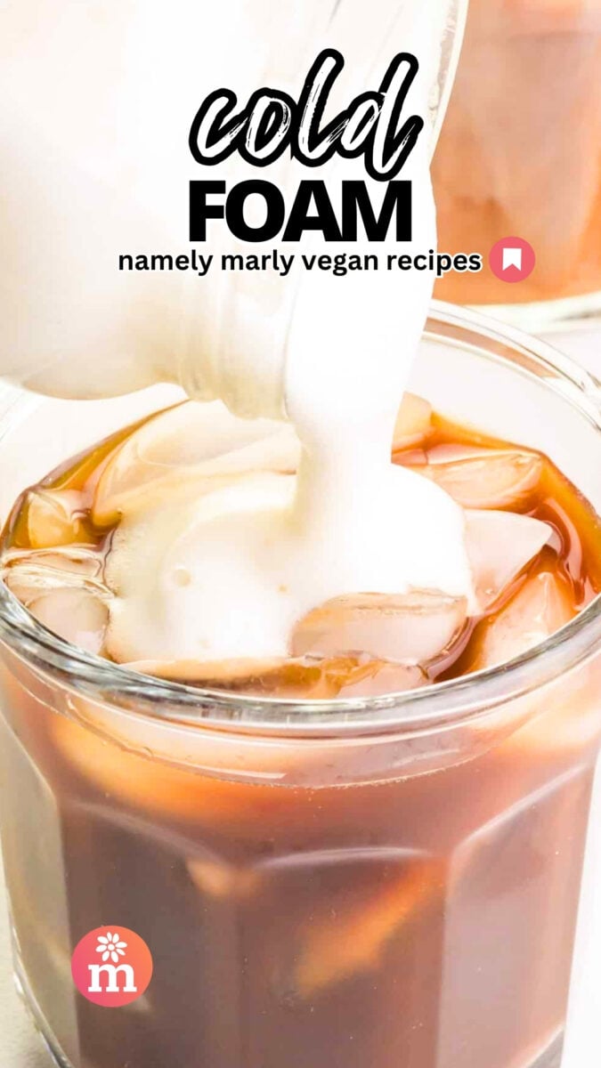 Foamy milk is being poured into a glass with iced coffee. The text reads, Cold Foam, Namely Marly Vegan Recipes.