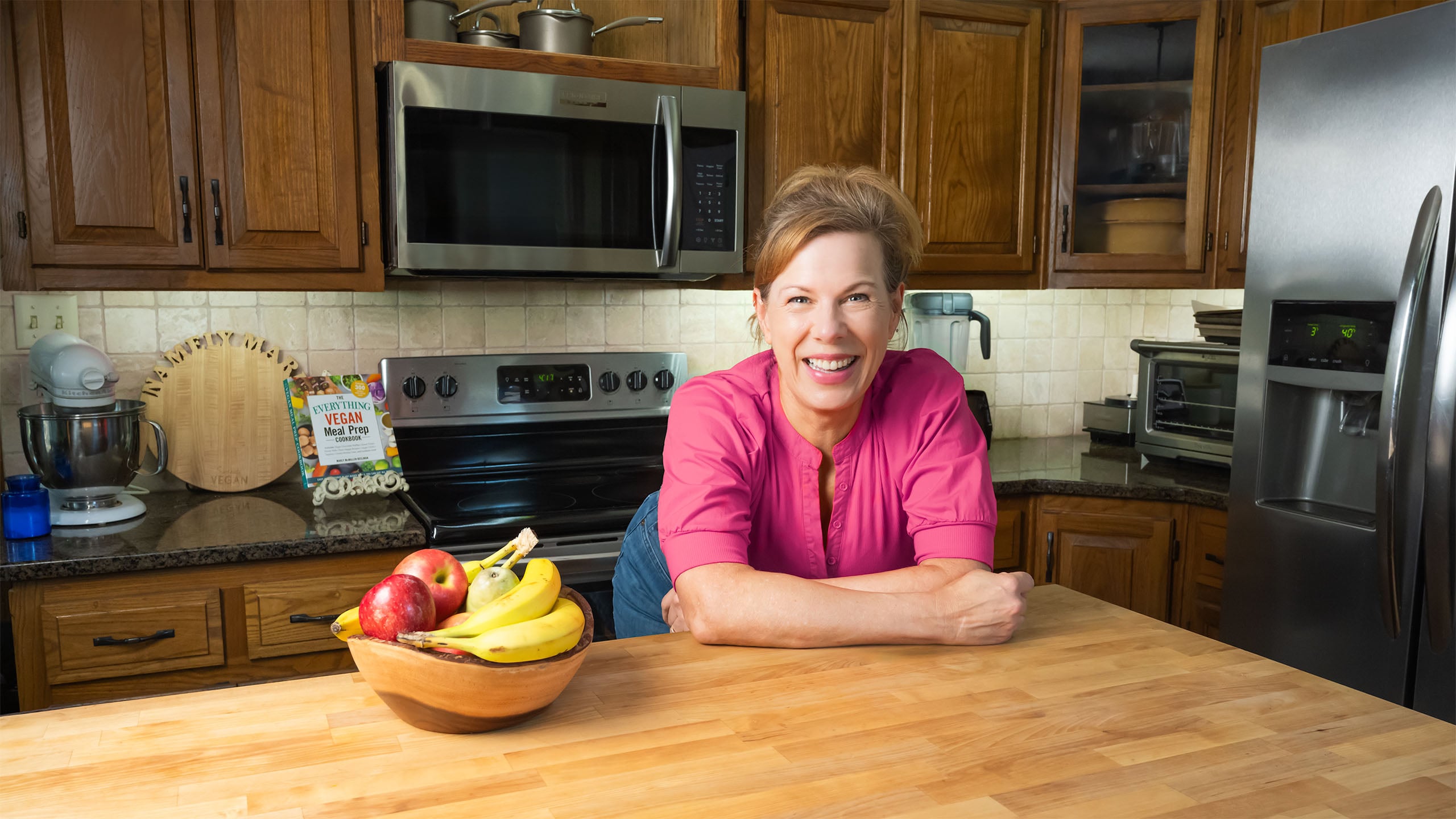 Marly leaning on the island in her kitchen