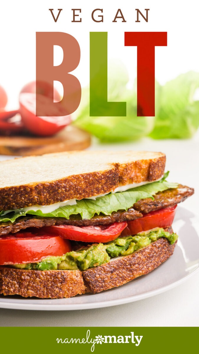 Vegan BLT sandwich with lettuce, tomatoes, guacamole, and vegan bacon on toasted bread.