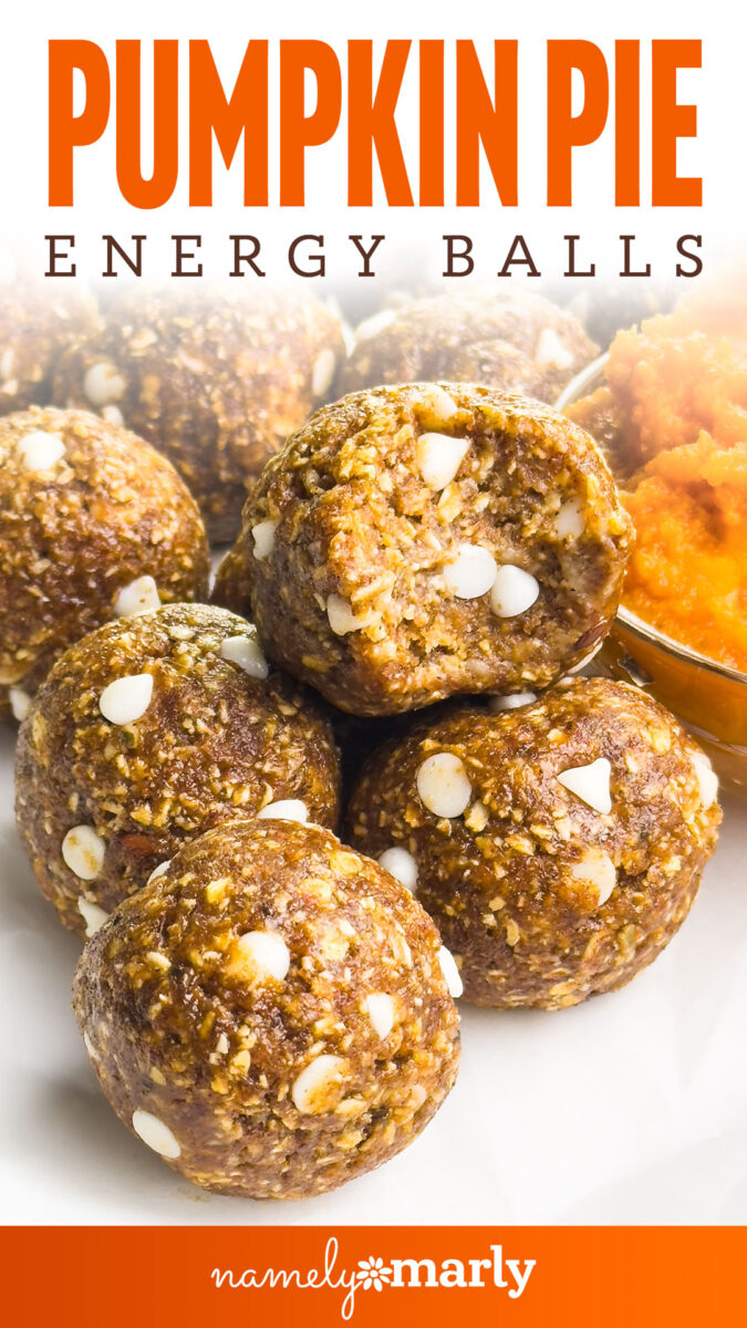 Pumpkin pie energy balls with white chocolate chips and a backdrop of mashed pumpkin.