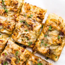Slices of BBQ Vegan Chicken Pizza on a white background.