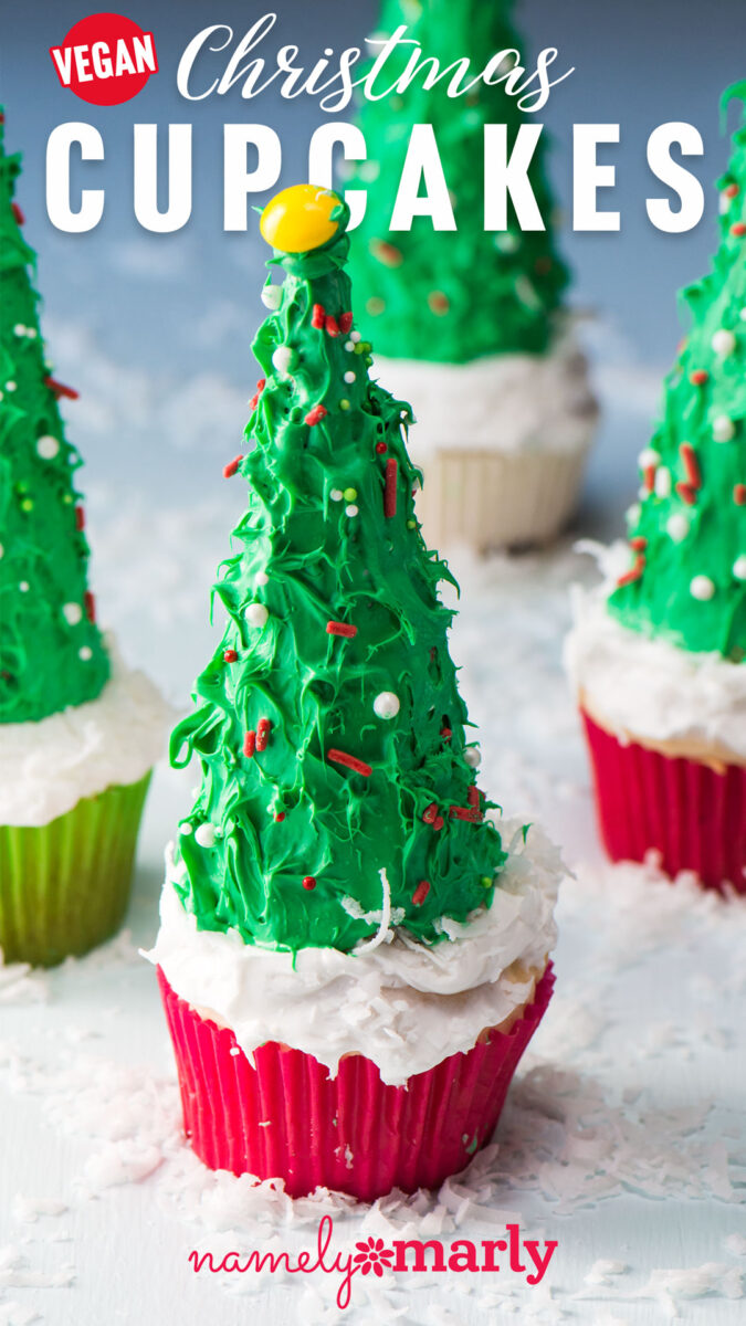 Three Christmas tree cupcakes sit on a grey table. The text reads, Vegan Christmas Cupcakes.