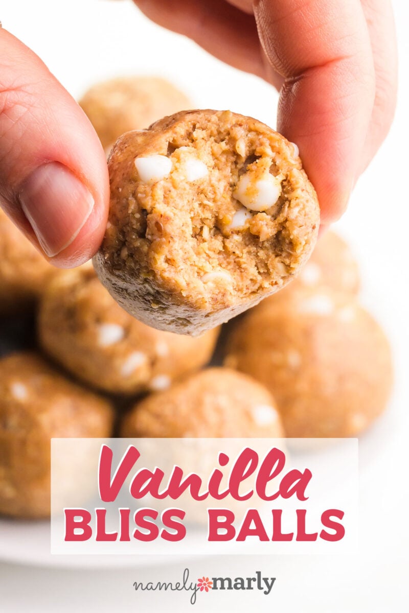 Vanilla Bliss Balls with an image of fingers holding a energy ball with a bite taken out showing white chocolate chips