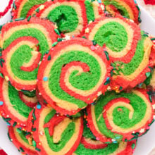 Looking down on a batch of Christmas pinwheel cookies on a plate.