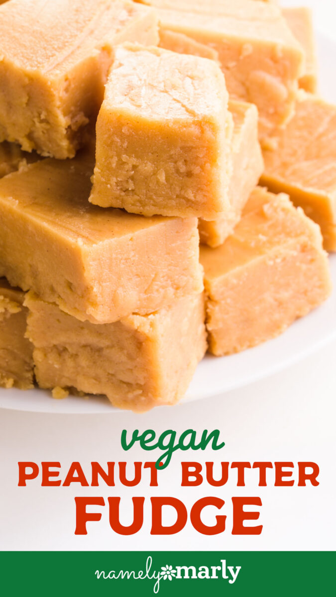 Vegan peanut butter fudge squares stacked on a white plate, creamy and smooth in texture.