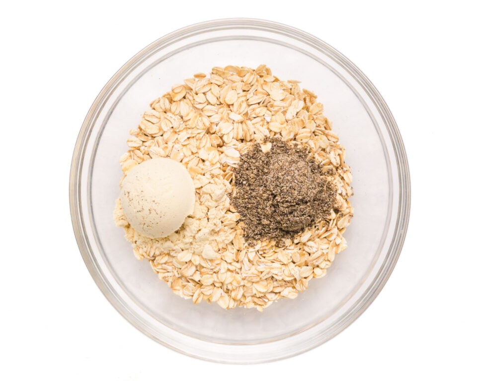 Looking down on a bowl of oats with chia seeds and protein powder.