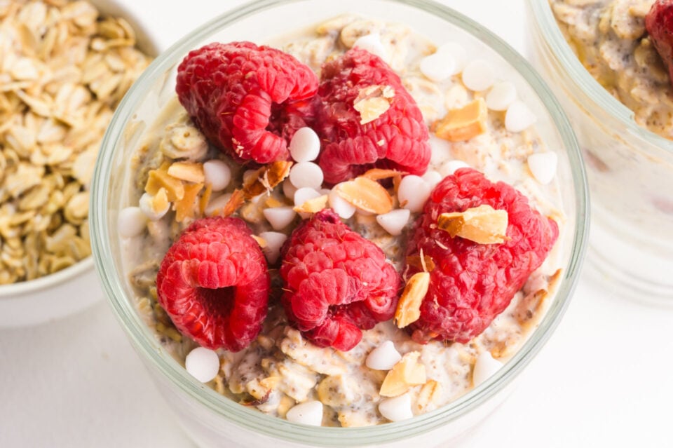 Looking down on a bowl of overnight oats with fresh raspberries on top.