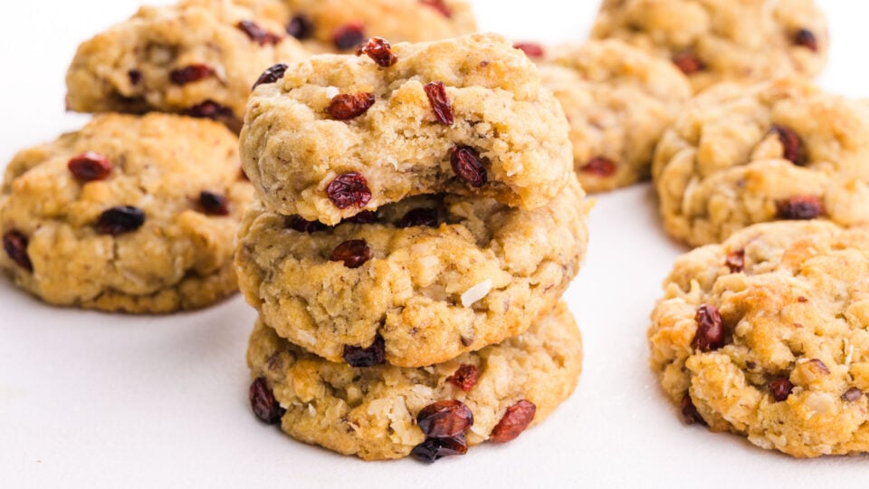 A stack of oatmeal cookies shows the top one with a bite taken out.