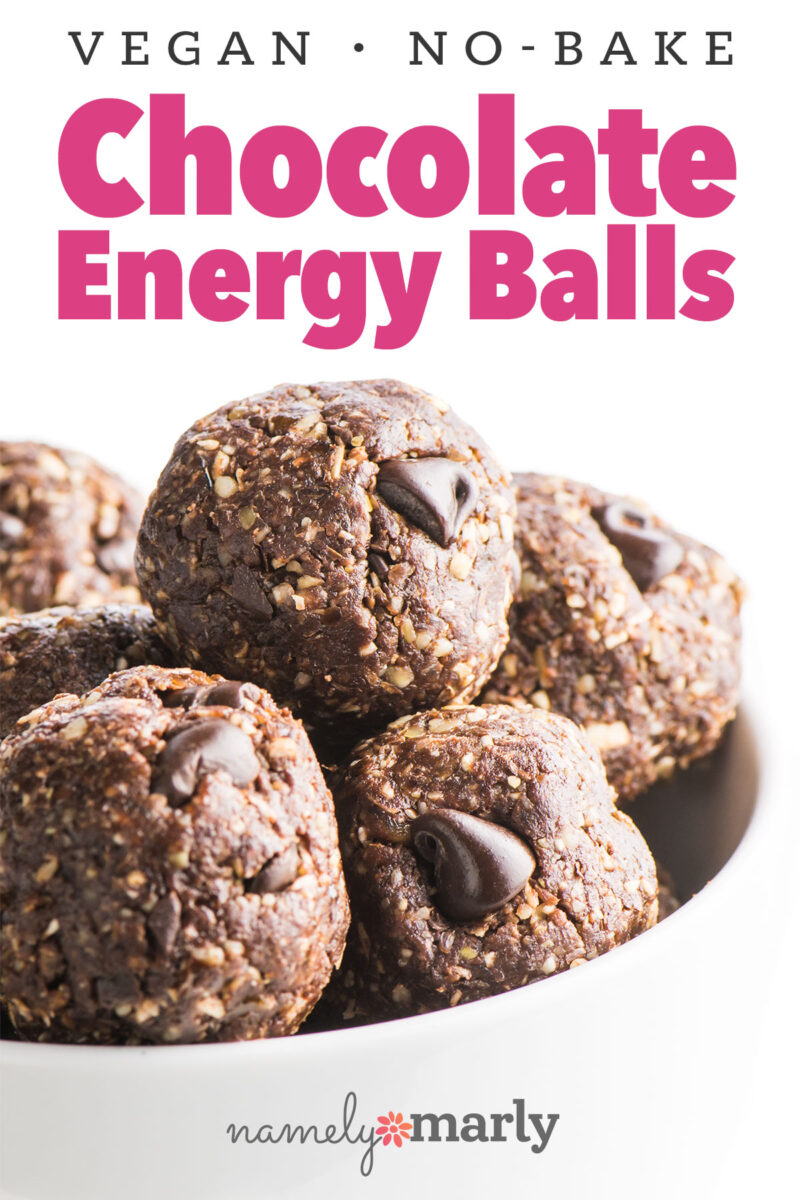 Bowl of vegan no-bake chocolate energy balls with chocolate chips on top.