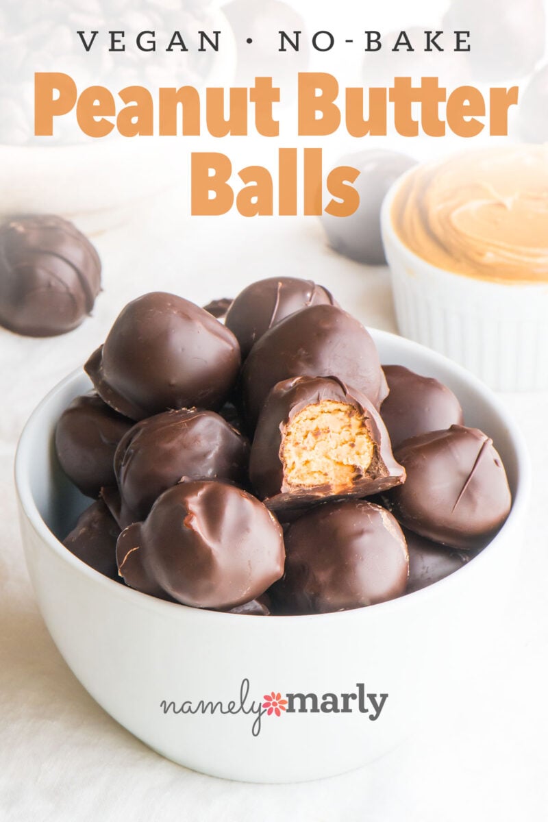 Vegan no-bake peanut butter balls in a bowl, some partially bitten to reveal the creamy filling inside.