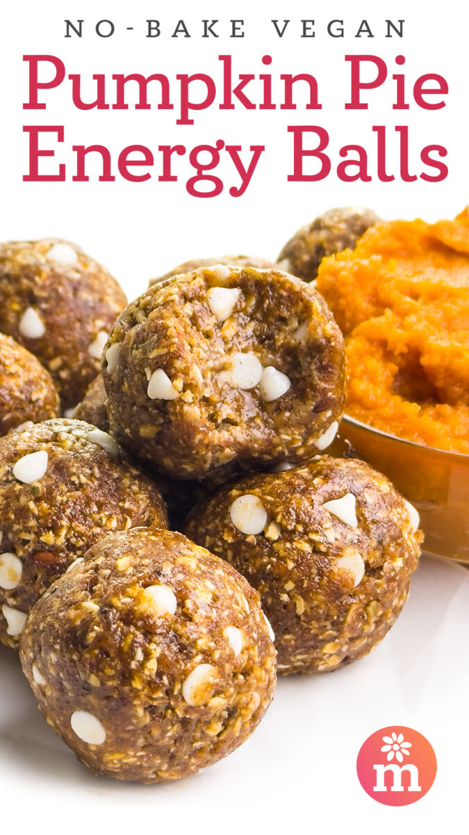 Vegan pumpkin pie energy balls with white chocolate chips and a bowl of pumpkin puree in the background.