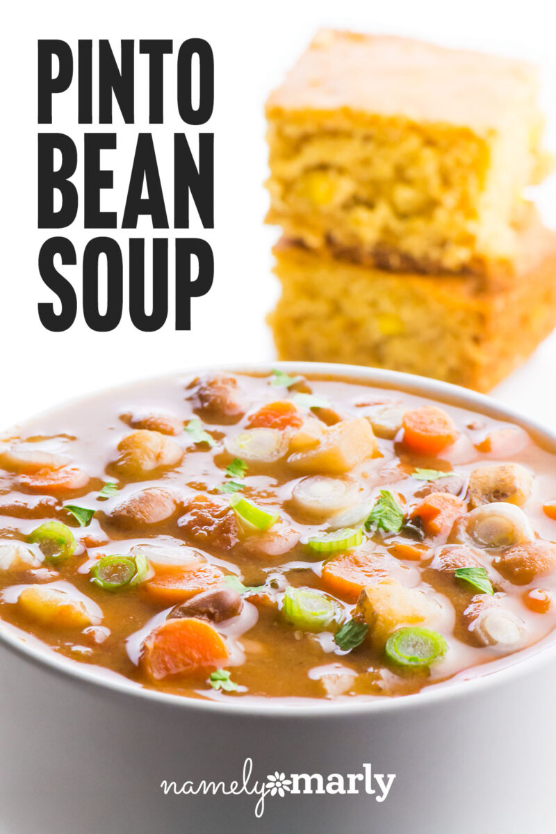 Pinto bean soup topped with green onions and coriander, accompanied by two pieces of cornbread.