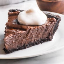A slice of vegan peanut butter pie sits on a plate.