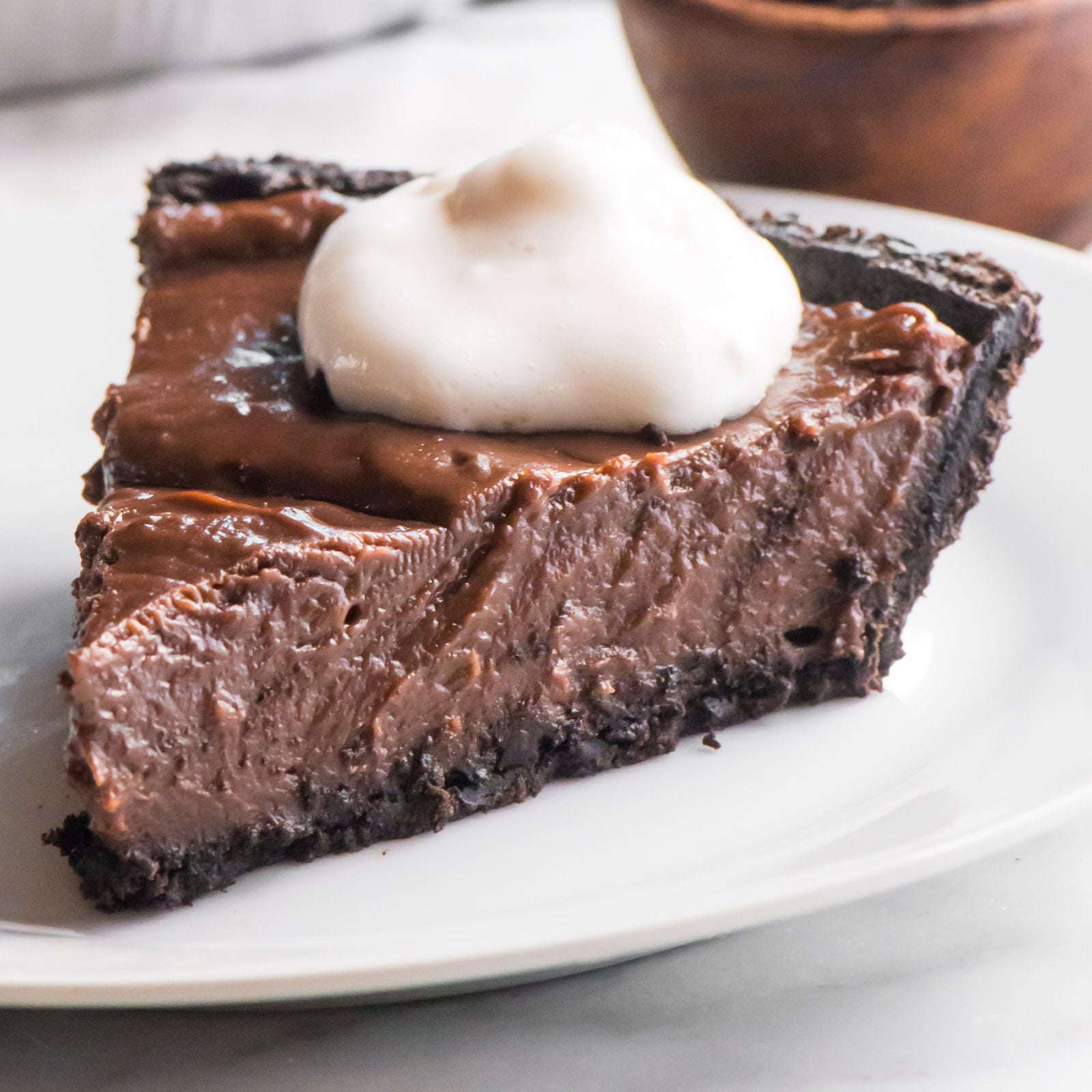 A slice of vegan peanut butter pie sits on a plate.
