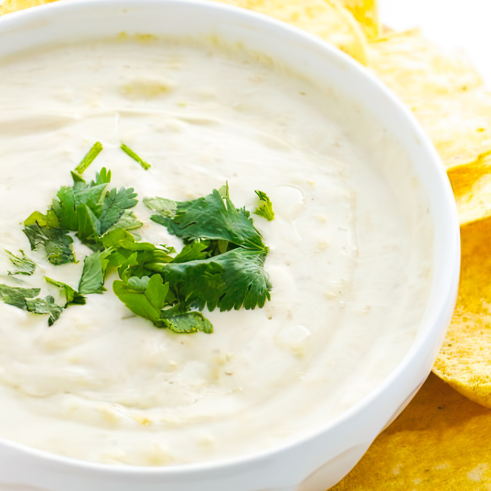Vegan Cheese Dip is surrounded by tortilla chips and ready to serve