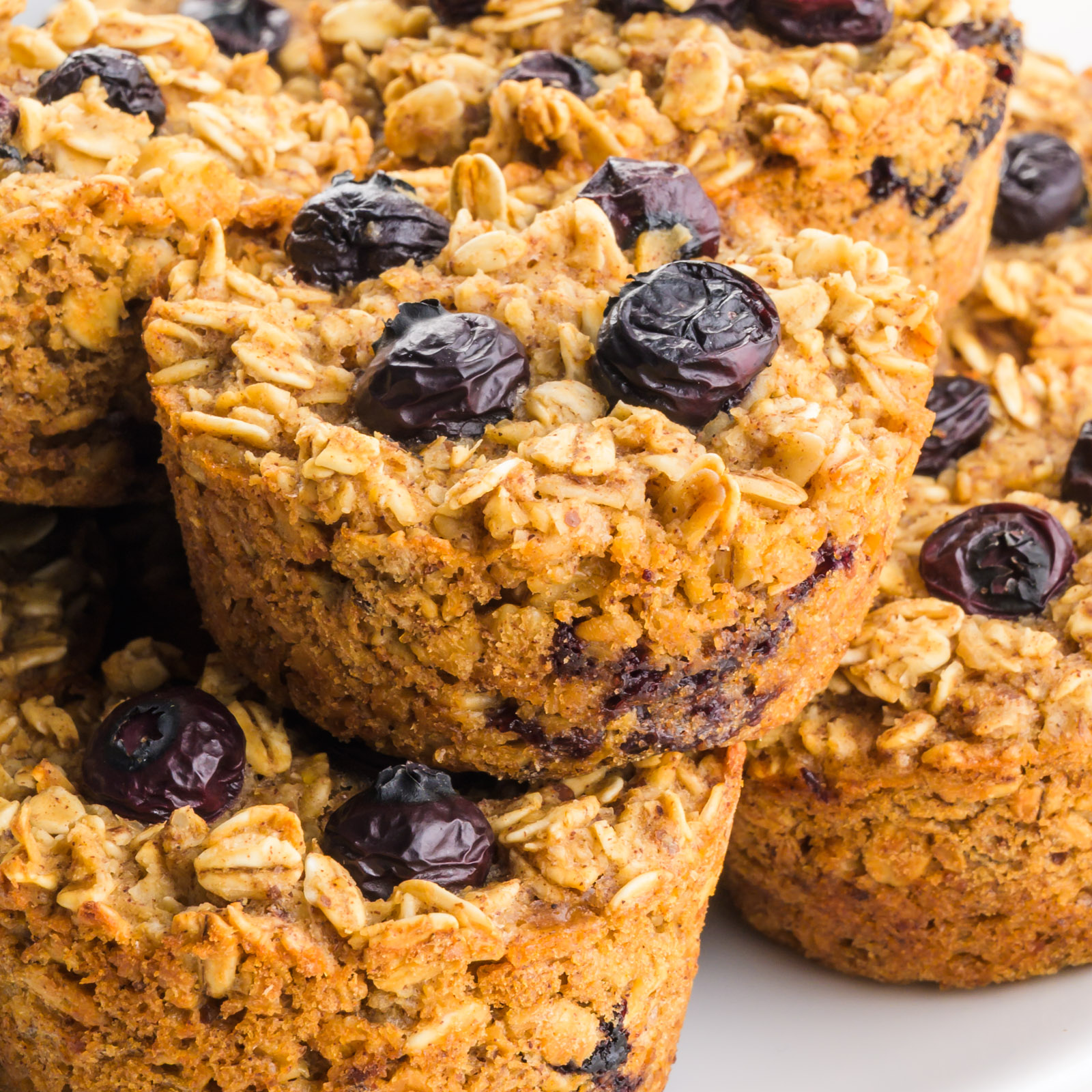 Several blueberry oatmeal cups on a plate.